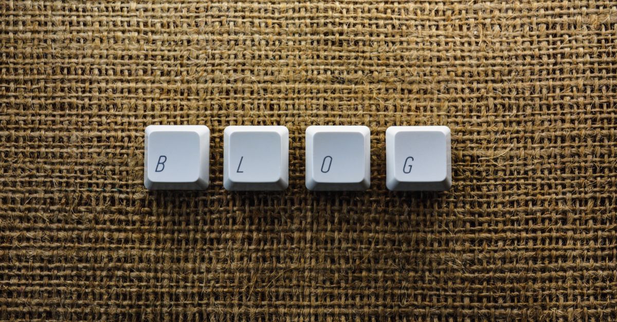 Close-up of keyboard keys spelling 'BLOG' on a burlap surface, ideal for tech blogs.